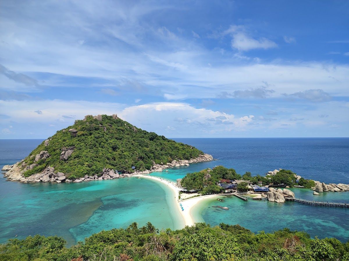 Koh Nang Yuan island seen from above — three rocky hills connected by white sandbars with turquoise water surrounding them