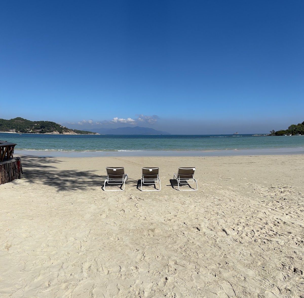 Choeng Mon Beach on Koh Samui — sheltered sandy bay with calm clear water, lined by tropical trees and resort buildings set back from the shore
