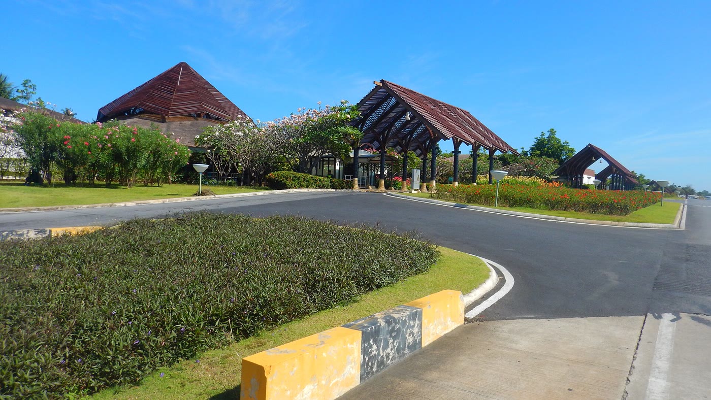 The check-in hall at Koh Samui Airport, an open timber terminal with a garden courtyard