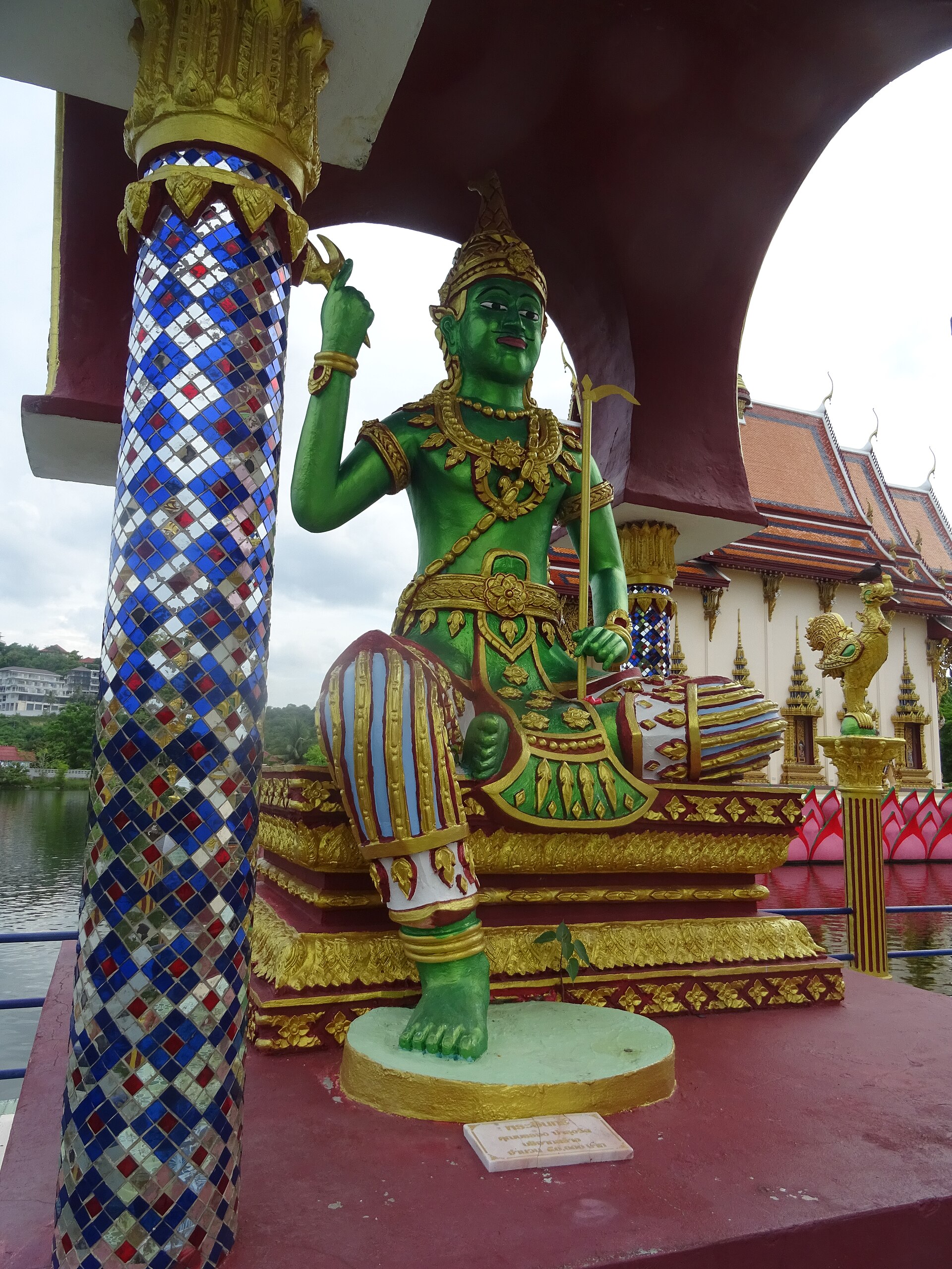 The main hall at Wat Plai Laem, with a multi-tiered red and gold roof and naga stairs