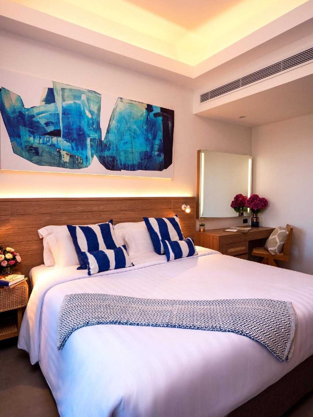 Bedroom at Absolute Sanctuary with a wooden bed, white linens and a balcony toward the garden