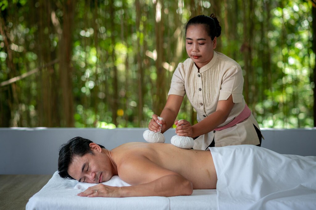 Spa treatment room at Absolute Sanctuary, with a massage bed and a folded towel