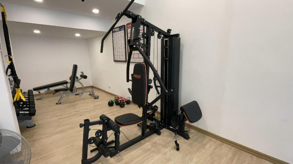 Beach Republic gym with weight machines, dumbbells and a sea view through the windows