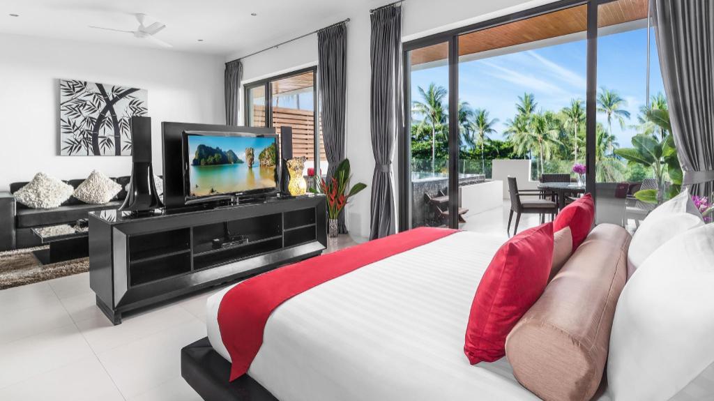 Beach Republic penthouse bedroom with a low platform bed, white linens and a balcony